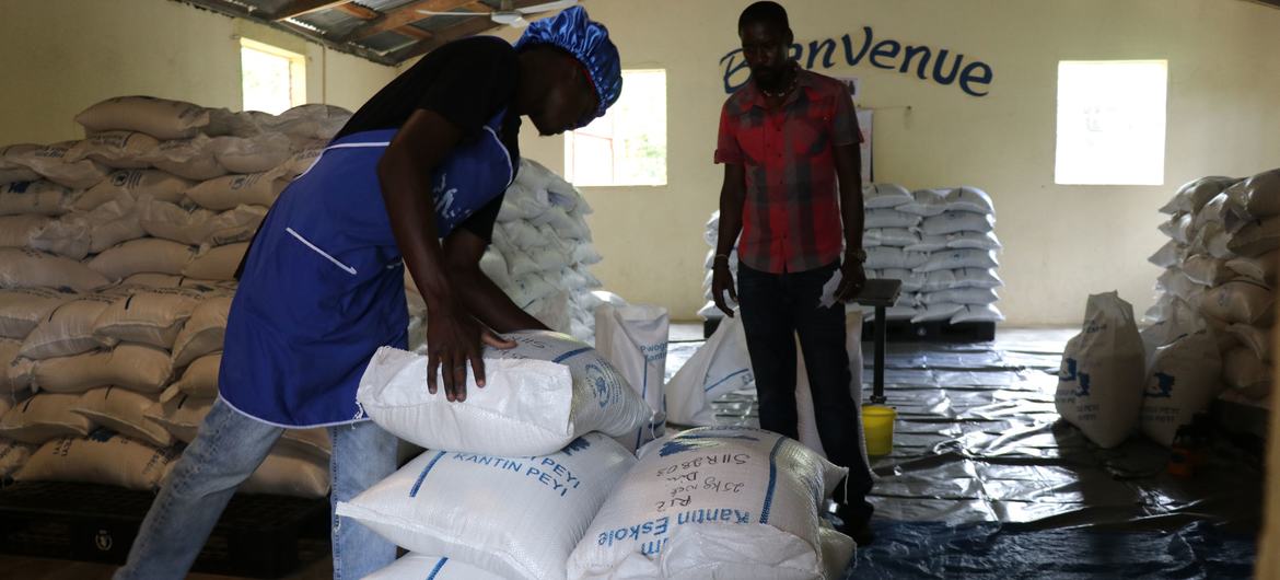 Workers in Haiti prepare humanitarian aid for distribution.