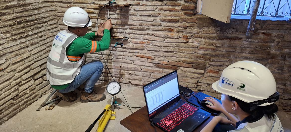 Technicians assess the structure of an historic building in Vigan.