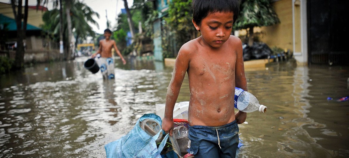 A boy drags possessions through the flooded streets of Manila in the aftermath of a typhoon. (file)