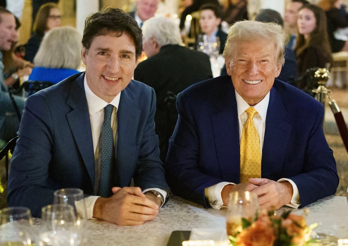 Prime Minister Justin Trudeau and President Donald Trump are sitting next to each other at a dinner table in Palm Beach, Florida. 