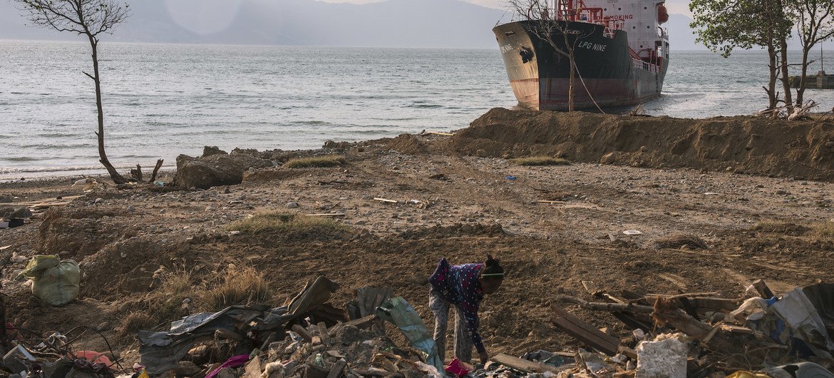 A woman in Indonesia searches through the rubble at a beach in Palu, Indonesia, that was entirely washed away by an October 2018  tsunami. (file)