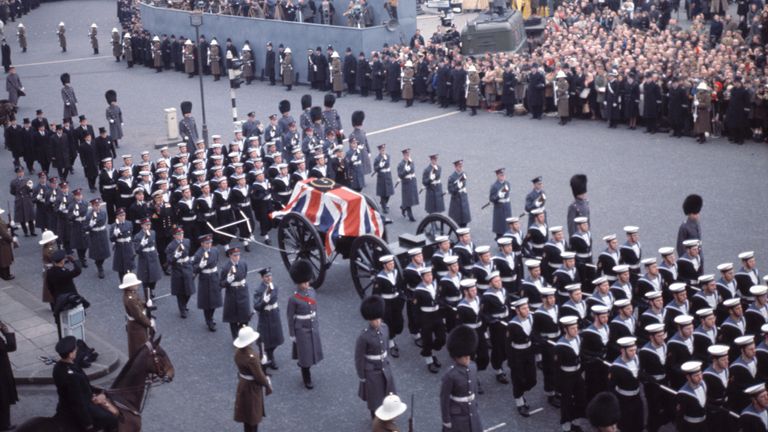 The Naval party drawing the gun carriage, bearing Sir Winston Churchill's coffin, moves slowly from Whitehall across a corner of Trafalgar Square, during the funeral procession to St. Paul's Cathedral, London, Jan. 30, 1965. (AP Photo)