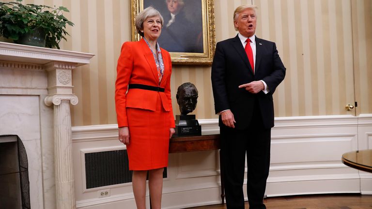 President Donald Trump points to the bust of British Prime Minister Winston Churchill as he poses for photographs with British Prime Minister Theresa May in the Oval Office of the White House in Washington, Friday, Jan. 27, 2017. (AP Photo/Pablo Martinez Monsivais)