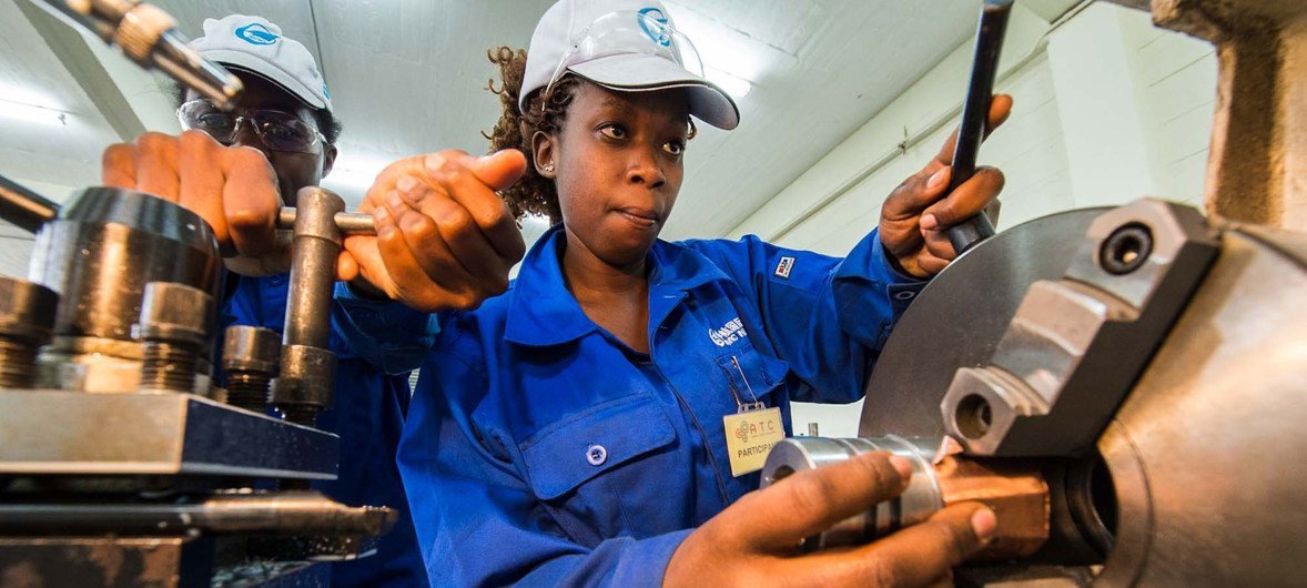 A woman in Kenya receives training at an engineering workshop.